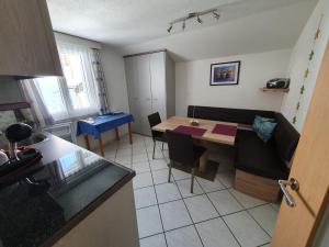 eine Küche und ein Esszimmer mit einem Tisch und Stühlen in der Unterkunft Apartmenthaus Holiday in Saas-Fee