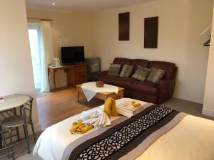 a living room with a bed and a couch at Hogwarts Bed and Continental Breakfast in Sheerness
