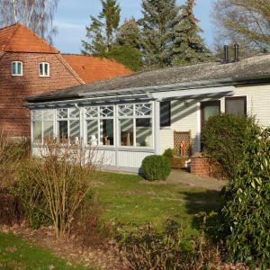 a conservatory with glass doors on a house at Zur Amsel in Damnatz +19 photos