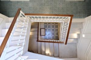 a staircase in a house with a mirror at Hotel Boutique Can Sastre in Ciutadella