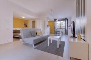 a living room with a couch and a table at Cruzeiro do Sul Apartments - Vilamoura center in Vilamoura