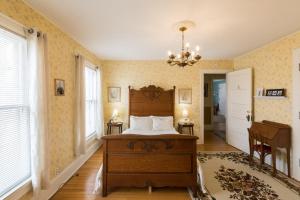 a bedroom with a bed and a chandelier at Ringling House Bed & Breakfast in Baraboo