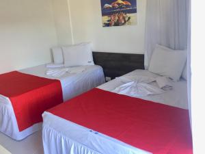 A bed or beds in a room at Nannai Beira Mar Porto de Galinha 207