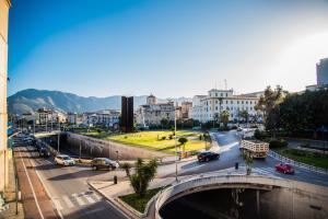 a city with a bridge and cars on the road at Porta Aragonese Luxury Rooms in Palermo