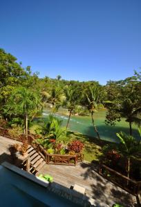 a view from the balcony of a resort with a river at Mahogany Hall Luxury Boutique Resort in San Ignacio