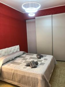 a bedroom with a bed with two towels on it at Holiday house in Lungomare Tysandros Giardini Naxos in Giardini Naxos