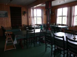 an empty dining room with tables and chairs at Jønndalen Høyfjellseter in Uvdal