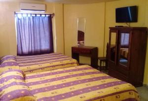 Postel nebo postele na pokoji v ubytování Hotel Quinta San Juan