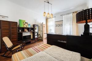 a bedroom with a bed and a tv and a chair at Art Dream Apartment in Budapest