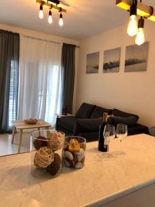 a living room with a table with glasses of wine at (L.I.H.8) Luxury Industrial House 8 in Nea Paphos
