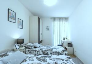 a bedroom with two beds and a window at Iris beach apartments in Kaštela