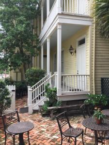 a patio with chairs and tables on a house at Terrell House Bed and Breakfast in New Orleans