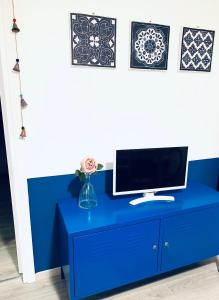 a blue desk with a computer on top of it at Acchiappasogni Holiday House in Malgrate