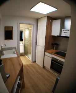 a small kitchen with white cabinets and a sink at Wanderlust Anduze in Anduze