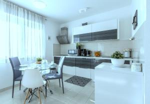a kitchen with a table and chairs in a room at Iris beach apartments in Kaštela