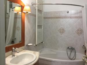 a bathroom with a white tub and a sink at Crispi Accomodation in Catania