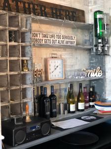 a bar with bottles of wine and a clock at Hotel Catania in Scarborough