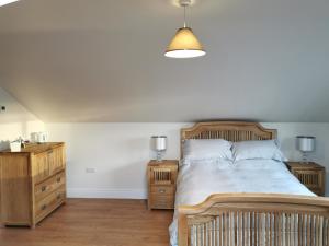 a bedroom with a wooden bed and two night stands at Slievescape in Newry