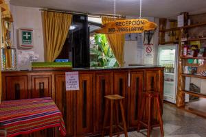 a bar with a sign that readsfreedom no unsafe drinks at Hostal Limoncocha in Tena