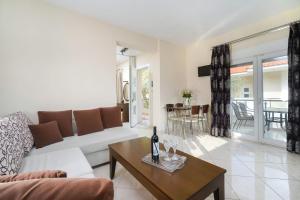 a living room with a couch and a table at Ilias Apartments in Chrysi Ammoudia