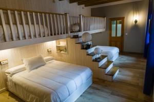 Almodóvar del Campo的住宿－Hospedium Hotel El Nido de Alcudia Suites，一间卧室配有一张床和一个楼梯间