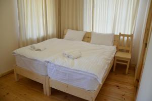 a bedroom with a bed with two towels on it at Petit Dilijan in Dilijan