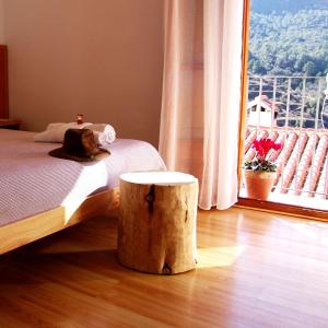 1 dormitorio con cama y tronco de árbol en Hotel La Tinensa en Puebla de Benifasar