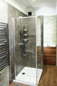 a shower with a glass door in a bathroom at Apartament Myślenice in Myślenice