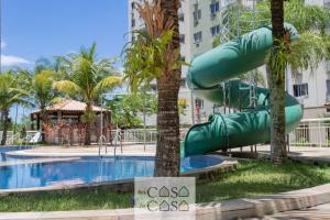 a water slide at a resort with a pool at 3 QUARTOS em Condominio com PISCINA, ESTACIONAMENTO e Portaria 24h a 300m do Centro de Convenções RIOCENTRO in Rio de Janeiro