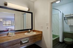 a bathroom with a toilet, sink, and shower at Expedition Lodge in Moab
