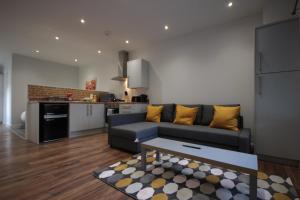 a living room with a couch and a kitchen at Studio 332 in Hull