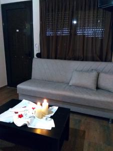a living room with a couch and candles on a table at Farma Giannis in Sarti