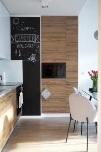 a kitchen with a chalkboard on the wall at Art Apartment in Giżycko