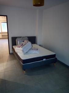 a bed sitting in a room with at Merlimont Plage - Paola in Merlimont
