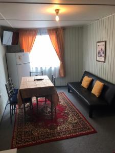 a living room with a table and a couch at Mar-al Apartments in Valdivia