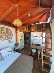 a bedroom with a bed and a wooden ceiling at Amarelo Hibisco in Guarda do Embaú