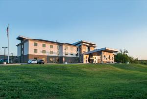 a large building with a grass field in front of it at Holiday Inn Express & Suites Shippensburg, an IHG Hotel in Shippensburg