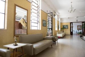 a lobby with a couch and chairs in a building at Grande Hotel Atibaia in Atibaia