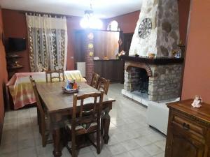 a dining room with a table and a fireplace at Residence ELIOS in Caramanico Terme