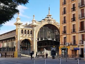 a large building with a fountain in front of it at Casco Histórico, con Parking incluido in Zaragoza