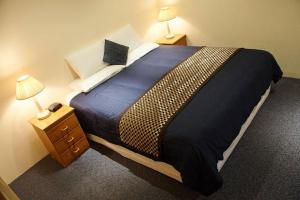 a bedroom with a bed and a night stand at Motel Mount Gambier in Mount Gambier