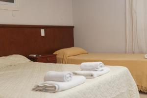 2 Handtücher auf einem Bett in einem Hotelzimmer in der Unterkunft Hotel Garden in San Miguel de Tucumán