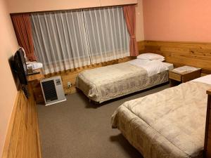 Postel nebo postele na pokoji v ubytování Turtle Inn Nikko