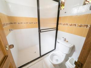 a bathroom with a shower and a toilet in it at Punta Caribana Casa Hotel in Necoclí