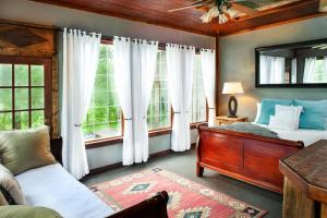 a bedroom with two beds and a window at Whimsical Gatehouse at Dark Horse Estate in Franklin