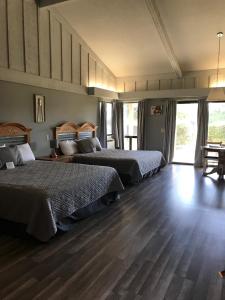a bedroom with two beds and a wooden floor at Ridgemark Golf Club and Resort in Hollister +135 photos