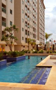 a swimming pool in a hotel with tall buildings at Salinas Park Resort in Salinópolis