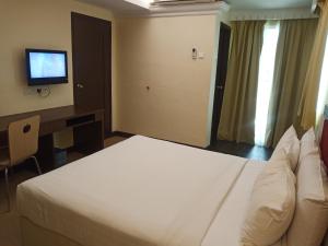 Tempat tidur dalam kamar di Hotel Taiping Perdana