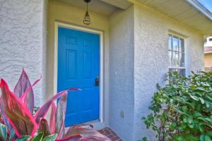 a blue door on a house with a plant at Ybor Casita! Steps away from Centro Ybor! in Tampa