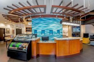 a food counter in a store with a painting on the wall at Hyatt Place Lake Mary/Orlando North in Lake Mary